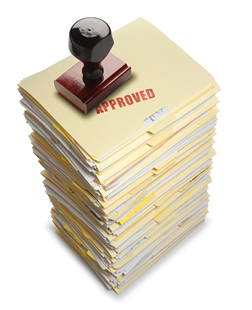 Pile of documents stamped 'approved'
