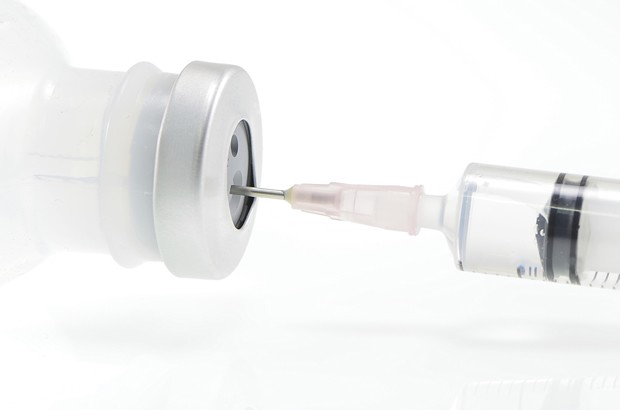 Close up view of medical glass ampoule and syringe