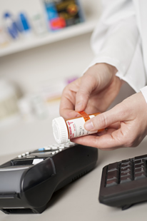 Pharmacist labelling a patients medicine