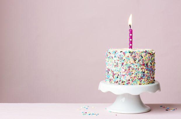 Birthday cake with one lit candle