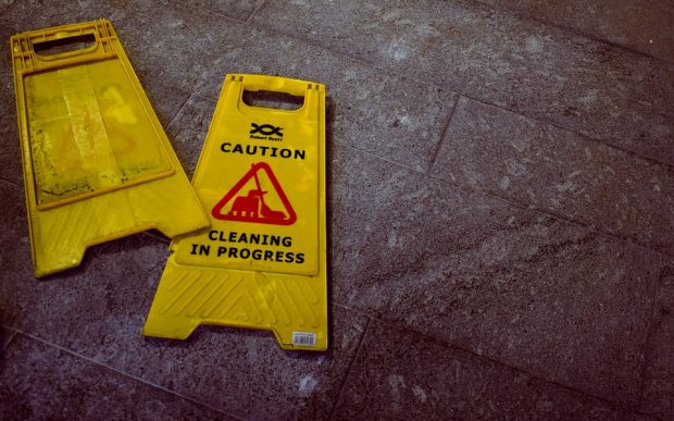 Yellow 'Cleaning in Progress' caution signs