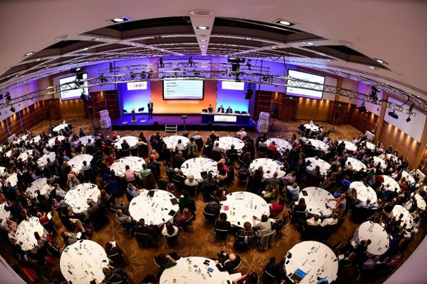 aerial view of 2018 GMP symposium: full house of seated attendees during a presentation