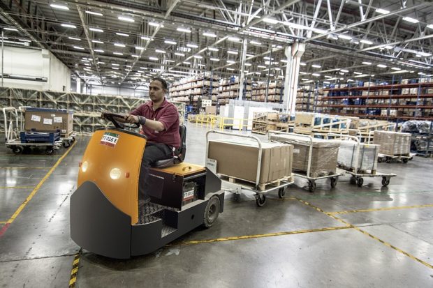 pallet truck driver moving cartons around a warehouse